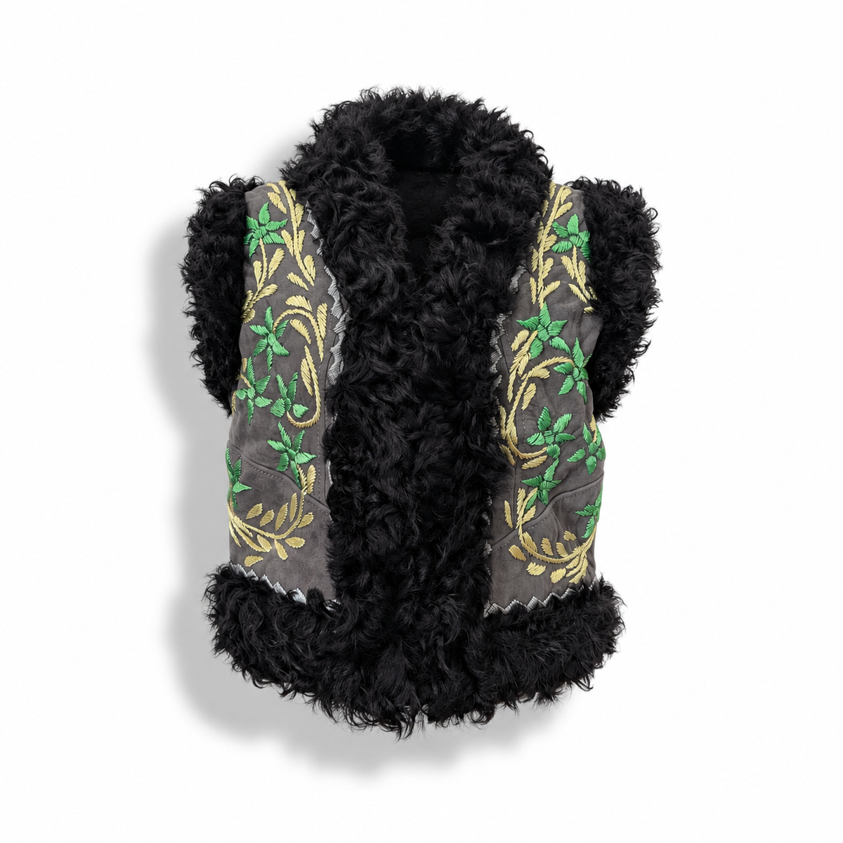 A black curly faux-fur vest with gray fabric panels on the sides featuring green floral embroidery and gold scrollwork, shown against a white background.