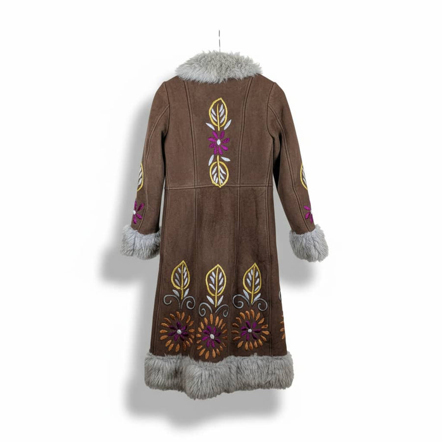 Brown coat with floral patterns and fur trim on a white background