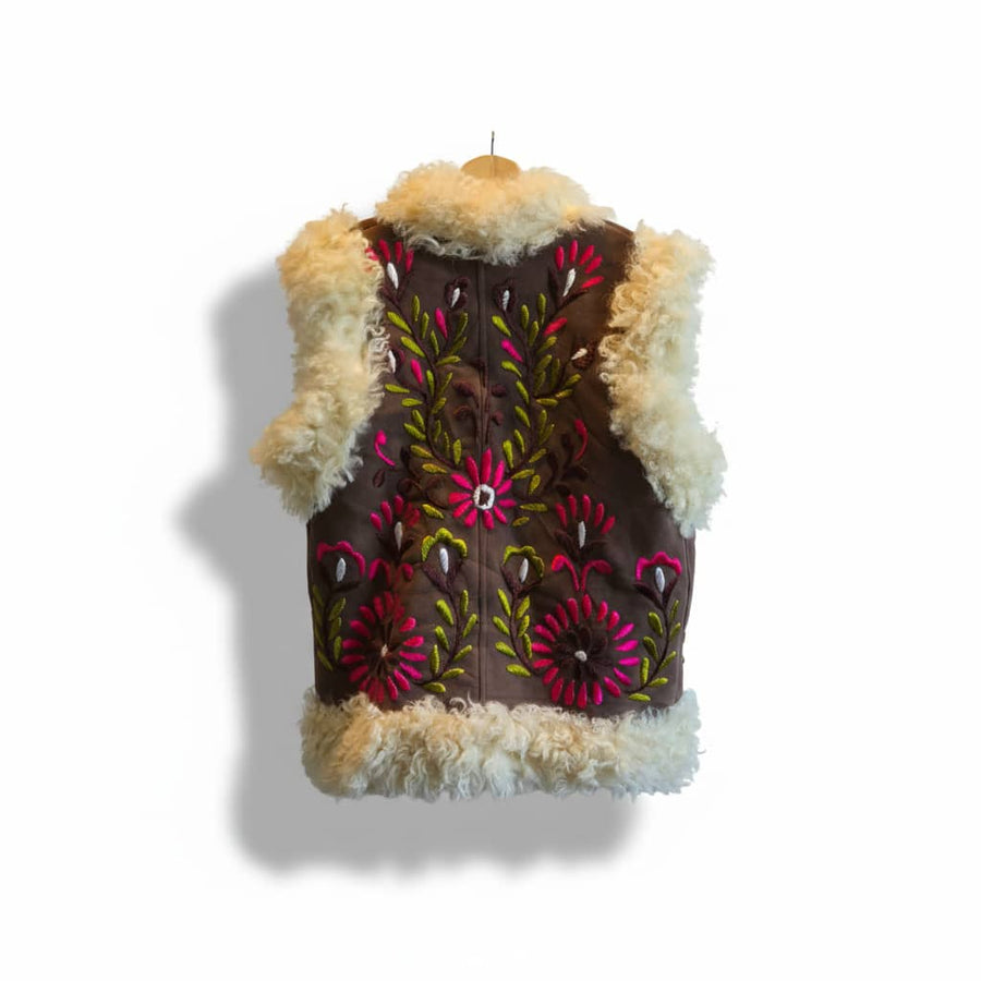 Vest with floral embroidery and fur trim on a white background