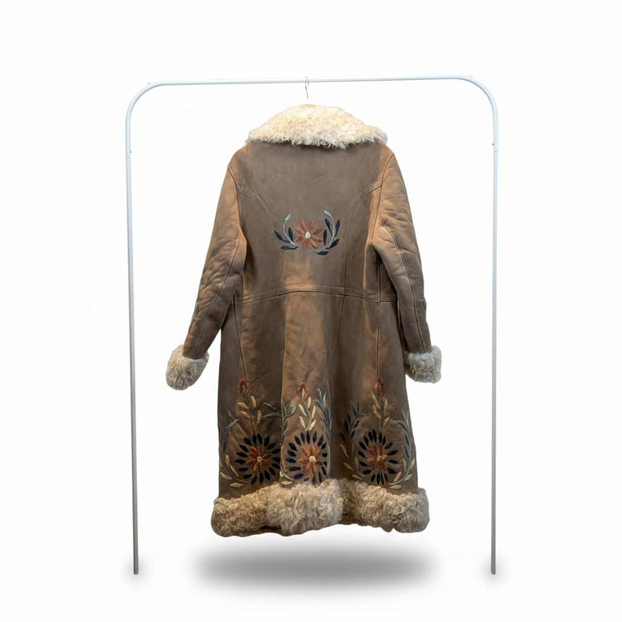 Brown leather coat with fur trim and floral embroidery on a white background