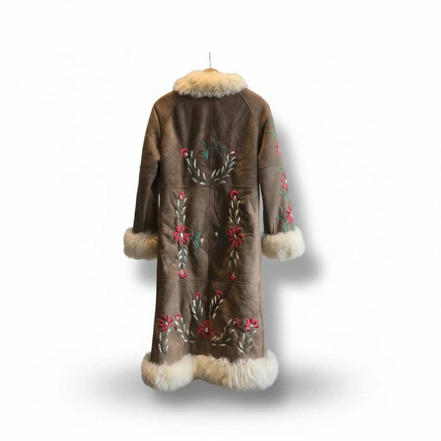 Back view of a brown coat with floral embroidery and cream fur trim at the collar and cuffs, on a white background.