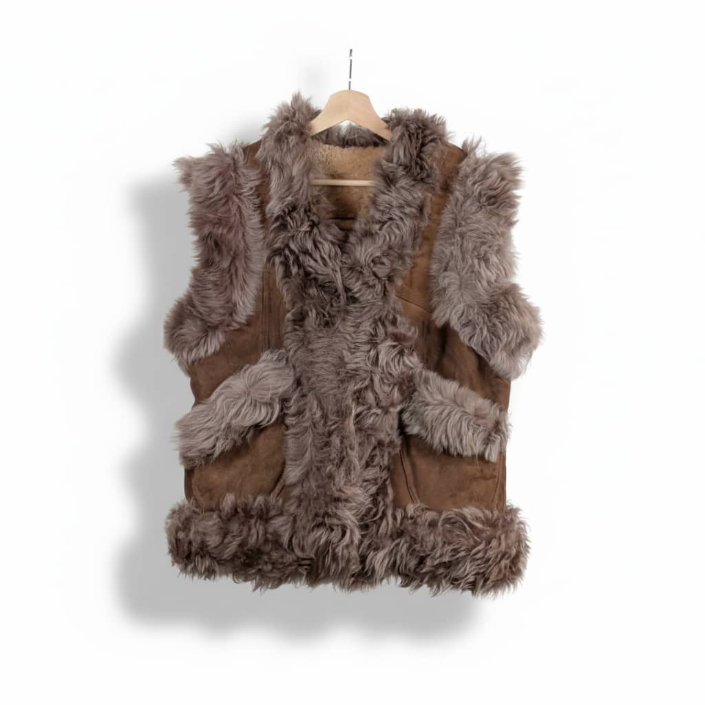 Brown fur vest on a hanger against a white background