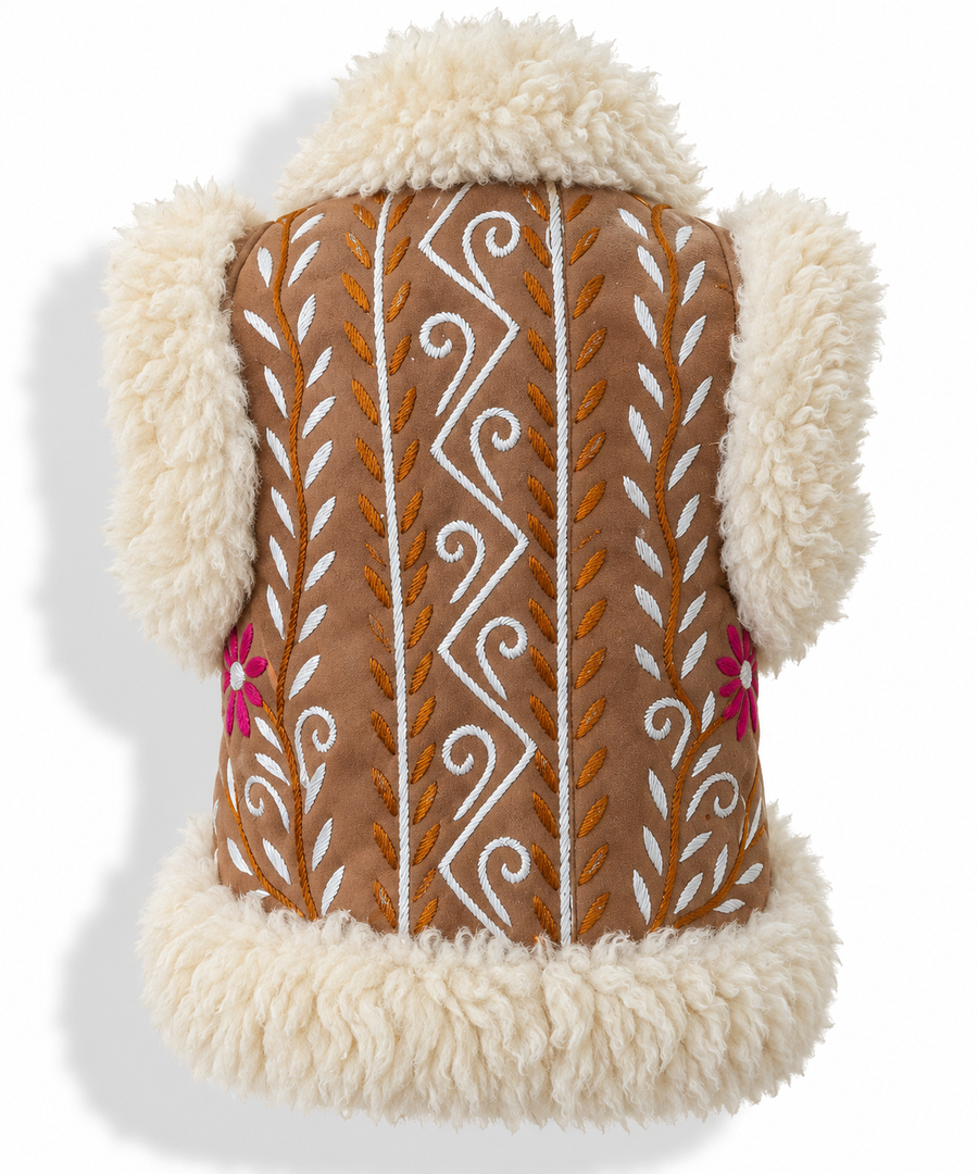 Back view of a brown faux-shearling vest with cream sherpa trim, featuring white and orange embroidered geometric and leaf patterns and small pink flowers on the front.