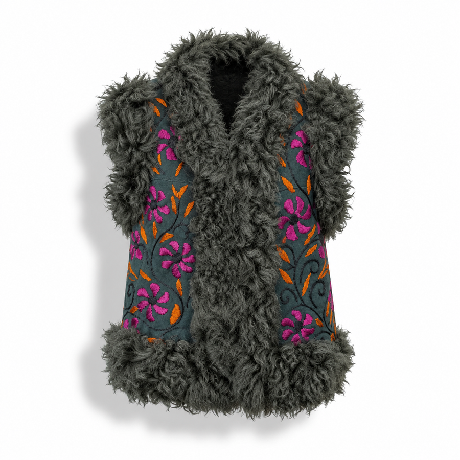 A sleeveless dark gray shaggy faux-fur vest with embroidered floral panels on the front. The embroidery features bright pink flowers, orange leaves, and dark green stems on a muted teal-gray background.