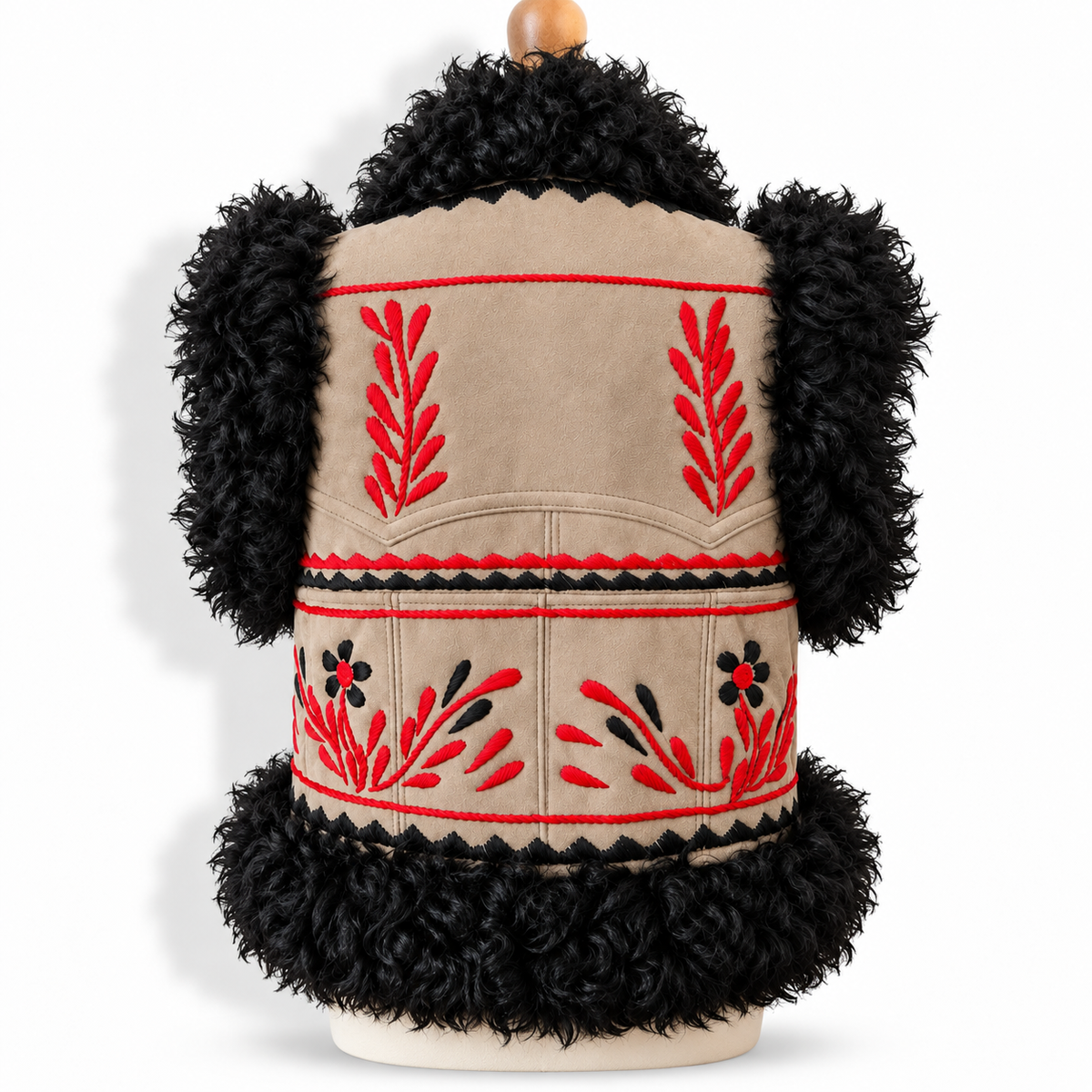 Back view of a beige shearling vest with black curly faux-fur trim, featuring red and black embroidered leaf and floral patterns, displayed on a mannequin torso against a white background.
