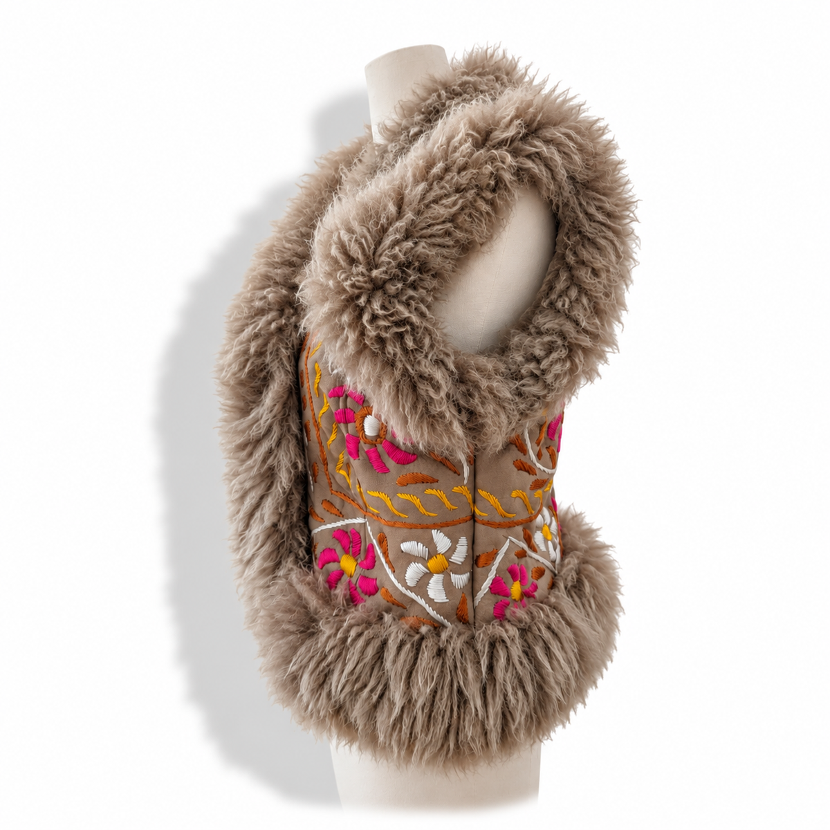 A brown faux fur vest with a matching faux fur collar, featuring colorful floral embroidery in pink, orange, yellow, and white on the front, displayed on a mannequin torso against a white background.