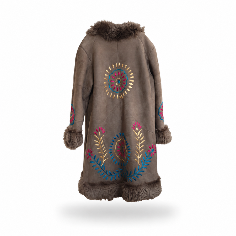 Back view of a brown suede coat with brown curly fur trim and colorful blue, pink and gold floral embroidery on a white background